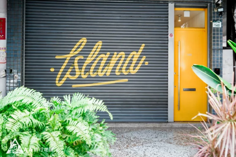 Si vienes durante el día y el pequeño bar de la isla de abajo aún no está abierto, habrá una puerta de hierro con letras amarillas como esta, y hay una puerta amarilla al lado, que es la puerta para entrar al pequeño apartamento de la isla.